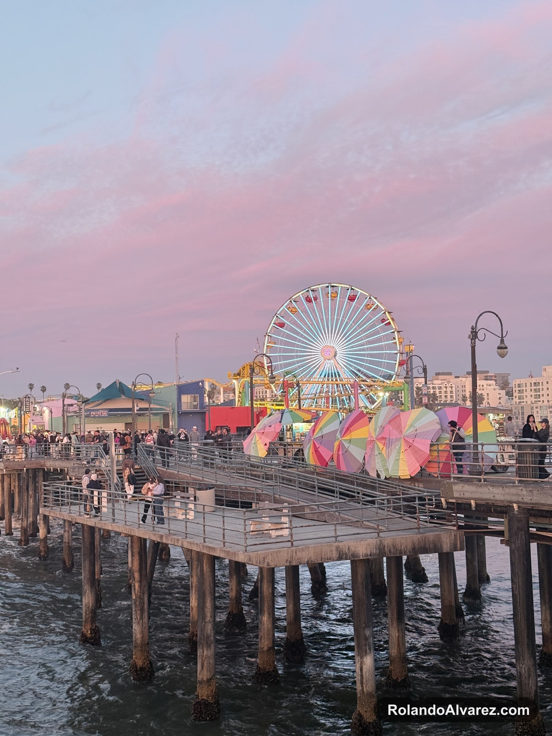 Santa Monica Pier Ferris wheel glowing beneath a pink evening sky