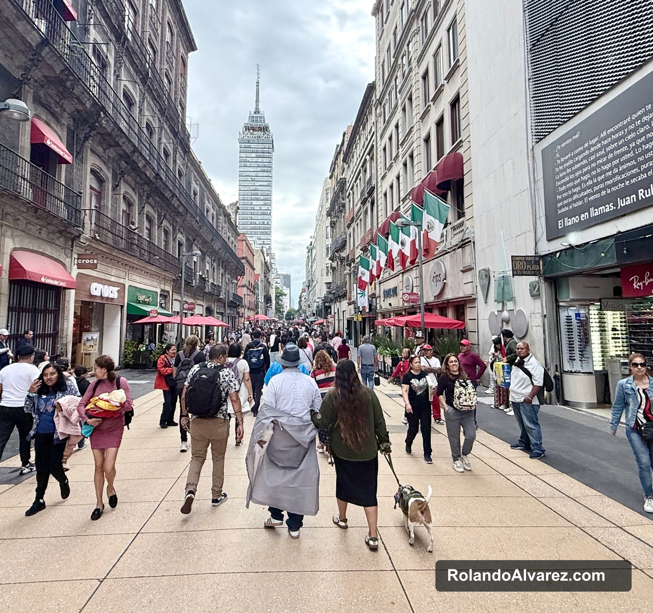 A busy Centro Histórico street leading toward Torre Latinoamericana